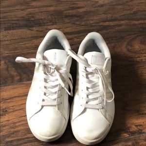 All white adidas sneakers w/ galaxy sign on back.